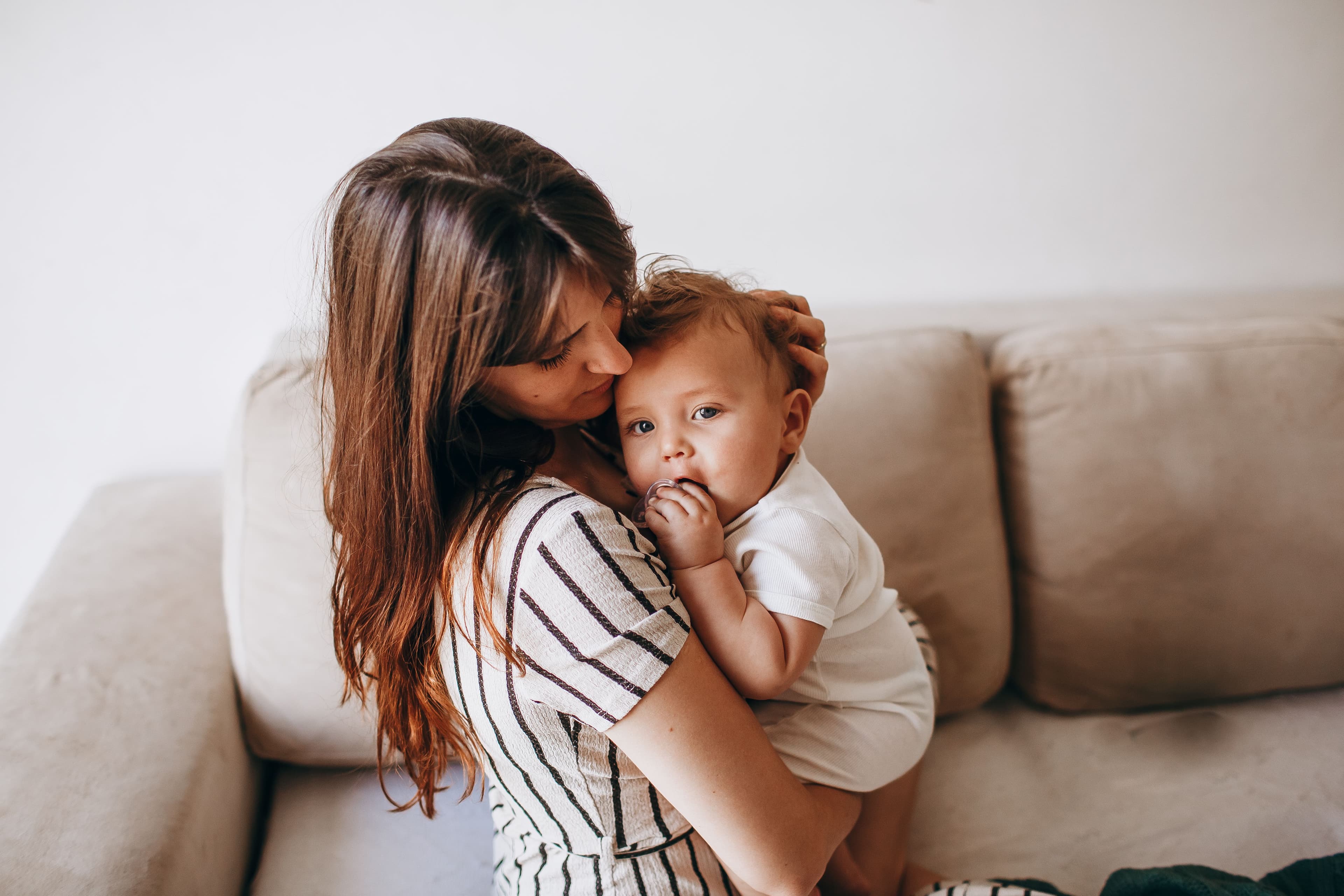 Mother with baby on sofa — perinatal mental health